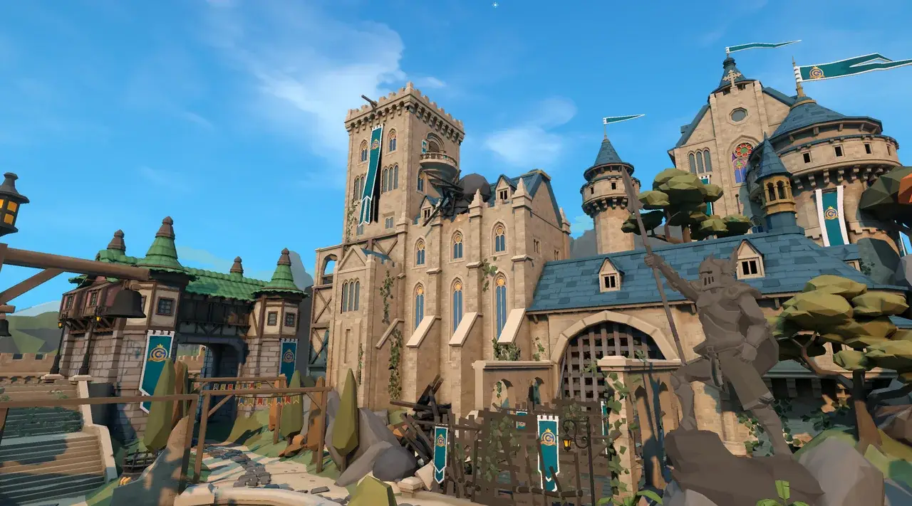 Medieval castle with tall keep, portcullis and knight statue under a blue sky