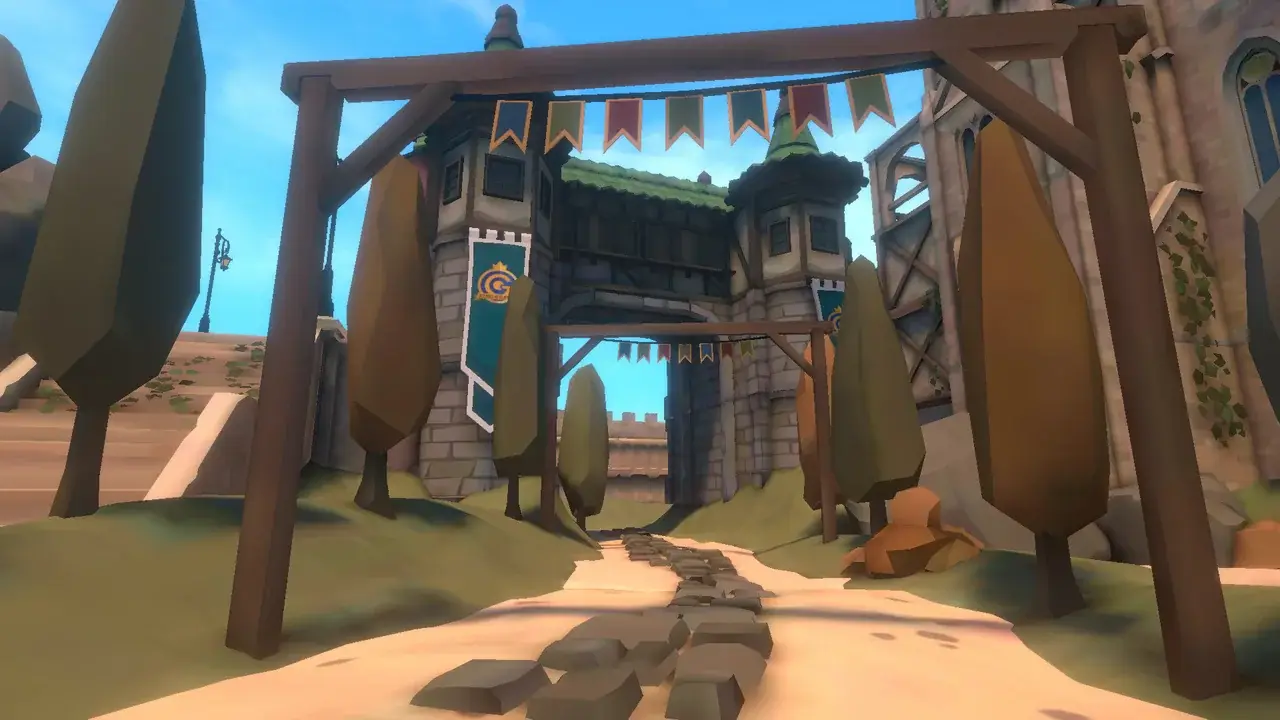 Wooden gate with bunting over a cobbled path to the castle gate
